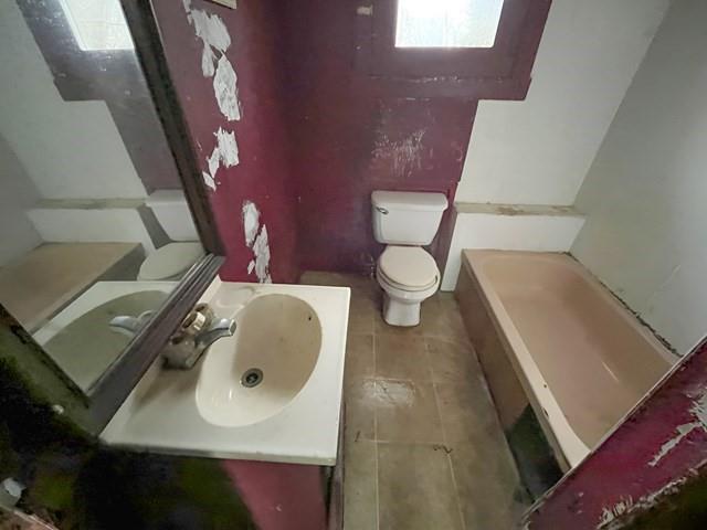 1027 Church Street Sagamore, PA 16250 - Photo 6 of 7 a bathroom with a toilet sink and mirror