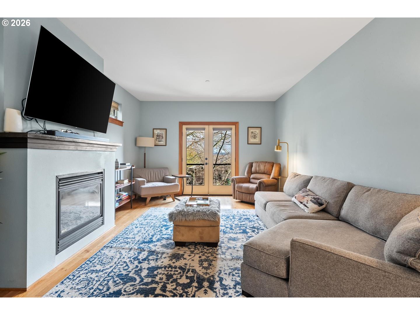5047 Southwest View Point Terrace, Unit C Portland, OR 97239 - Photo 12 of 38 a living room with furniture a flat screen tv and a fireplace
