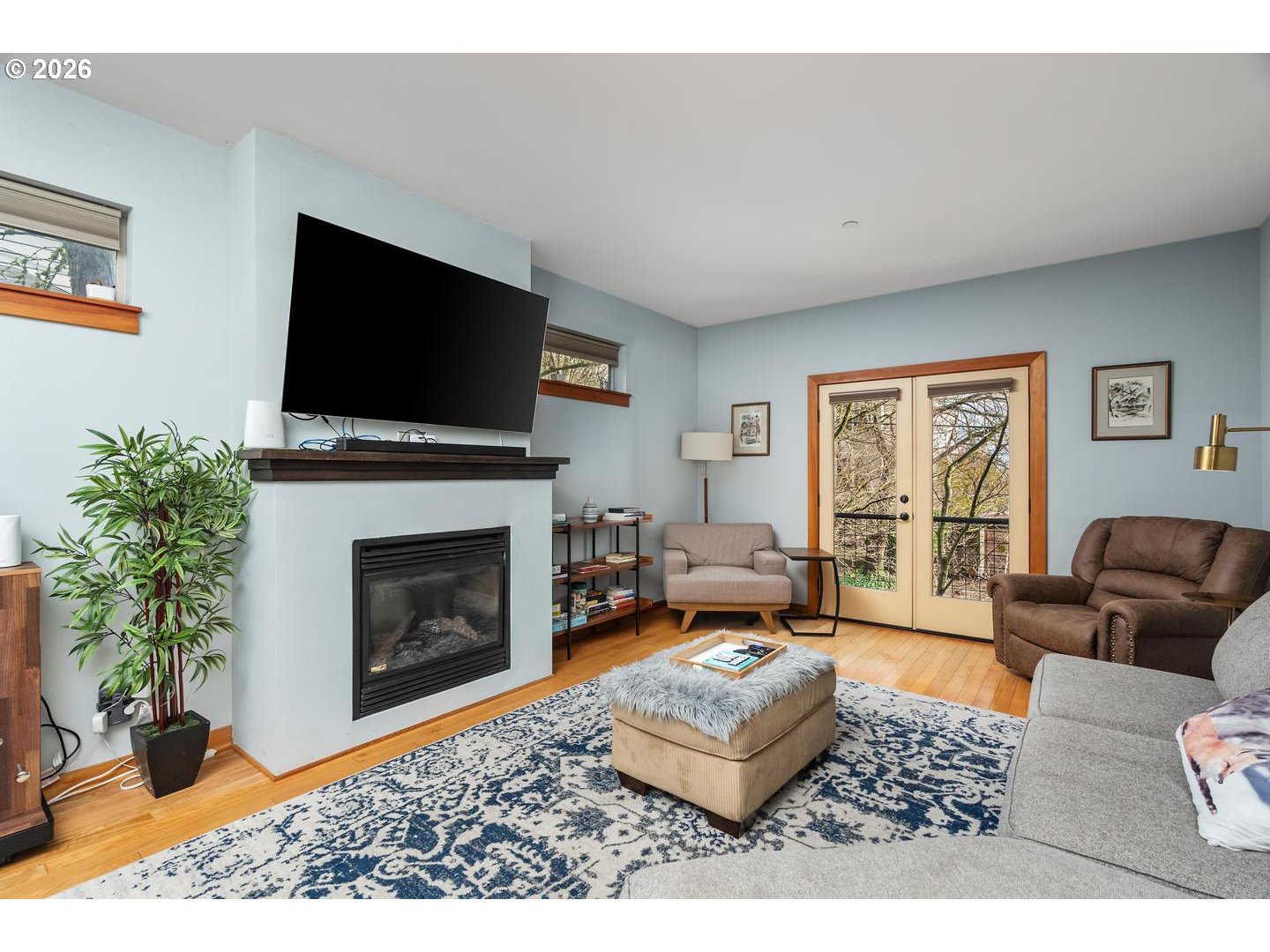 5047 Southwest View Point Terrace, Unit C Portland, OR 97239 - Photo 13 of 38 a living room with furniture a flat screen tv and a fireplace