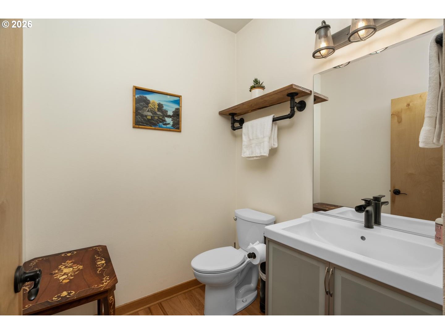 5047 Southwest View Point Terrace, Unit C Portland, OR 97239 - Photo 17 of 38 a bathroom with a toilet a sink and mirror