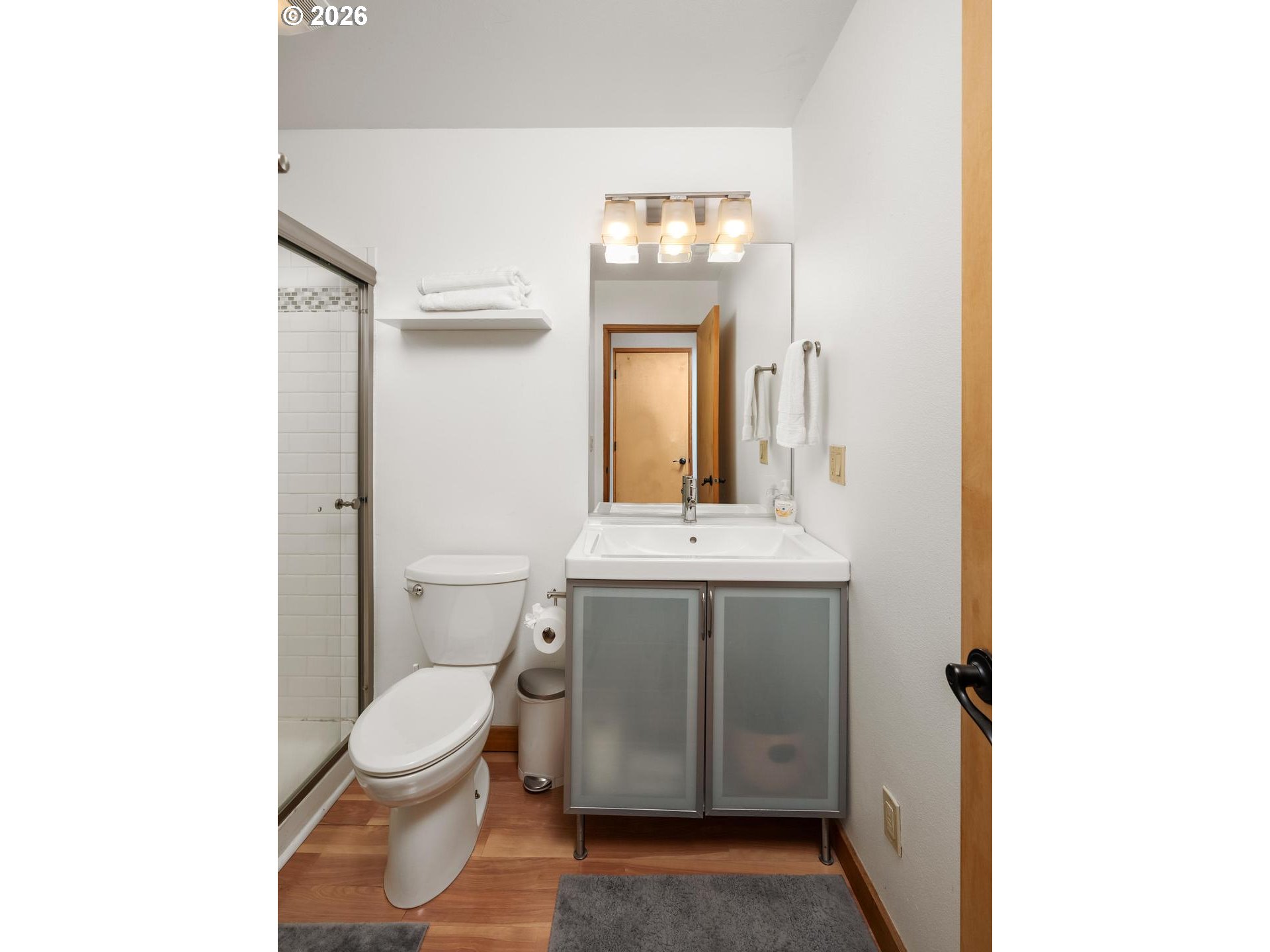 5047 Southwest View Point Terrace, Unit C Portland, OR 97239 - Photo 23 of 38 a bathroom with a sink a toilet and mirror