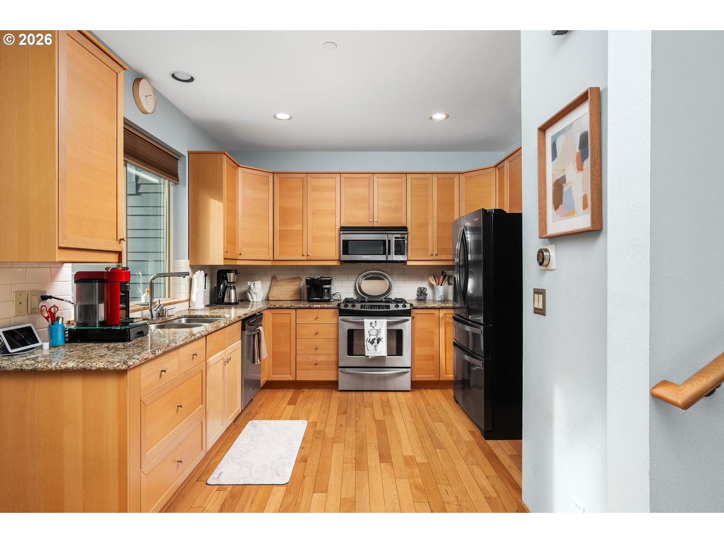 5047 Southwest View Point Terrace, Unit C Portland, OR 97239 - Photo 7 of 38 a kitchen with stainless steel appliances granite countertop a refrigerator a stove top oven a sink and dishwasher