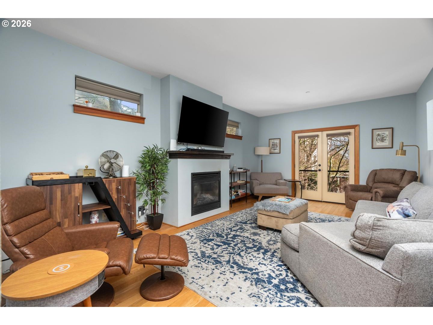 5047 Southwest View Point Terrace, Unit C Portland, OR 97239 - Photo 10 of 38 a living room with furniture a flat screen tv and a fireplace