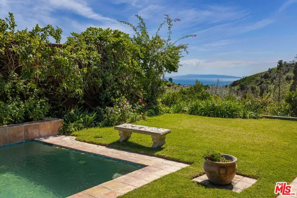 a view of a swimming pool with a yard
