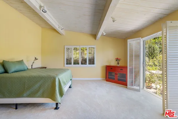 a large bedroom with a large bed and a large window