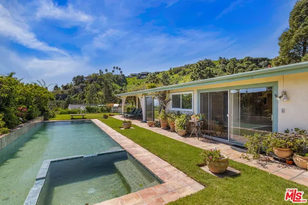 a view of a swimming pool with a patio