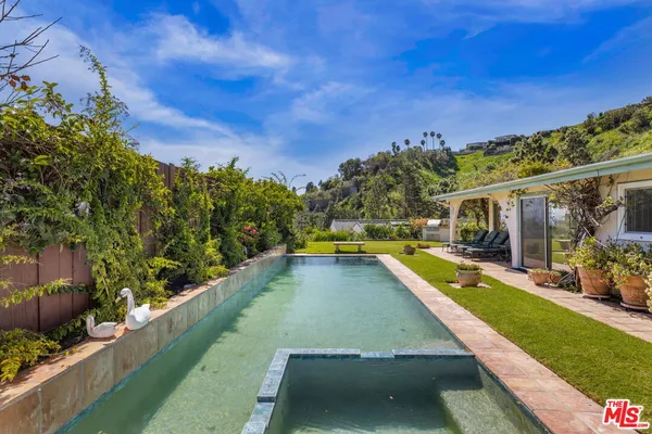 a view of a back yard of the house with a yard