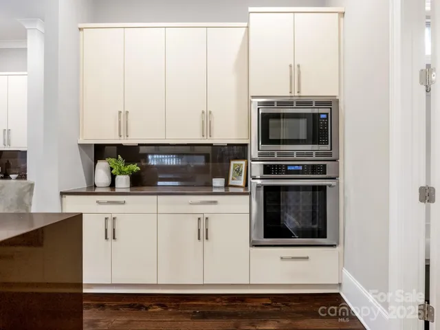 a kitchen with stainless steel appliances a stove a microwave and cabinets