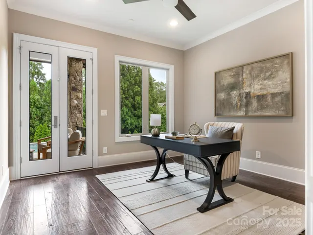 a view of a workspace with furniture and a window
