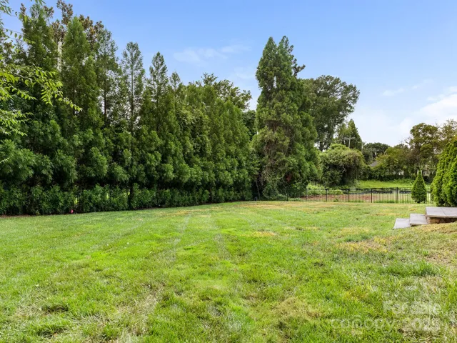 a view of outdoor space with a garden and trees