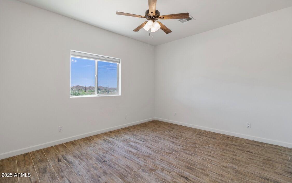 48126 North Coyote Pass Road New River, AZ 85087 - Photo 14 of 23 wooden floor in an empty room with a window