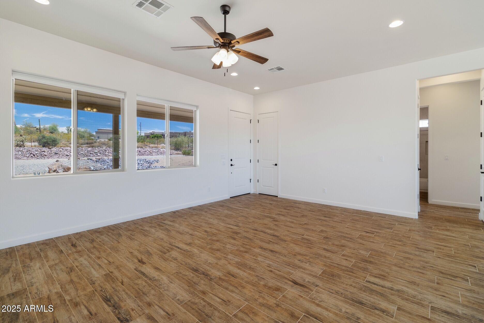 48126 North Coyote Pass Road New River, AZ 85087 - Photo 2 of 23 wooden floor in an empty room with a window