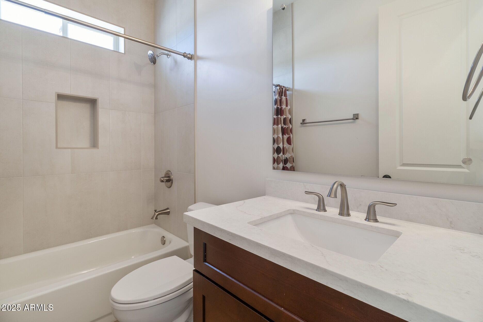 48126 North Coyote Pass Road New River, AZ 85087 - Photo 10 of 23 a bathroom with a sink a toilet and a bathtub