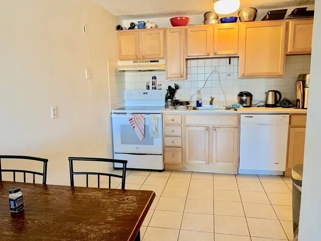 a kitchen with stainless steel appliances granite countertop a sink and cabinets