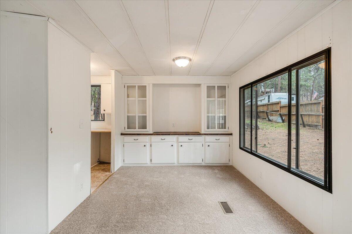 60214 Agate Road Bend, OR 97702 - Photo 8 of 31 Dining area with large window and built-in cabinetry