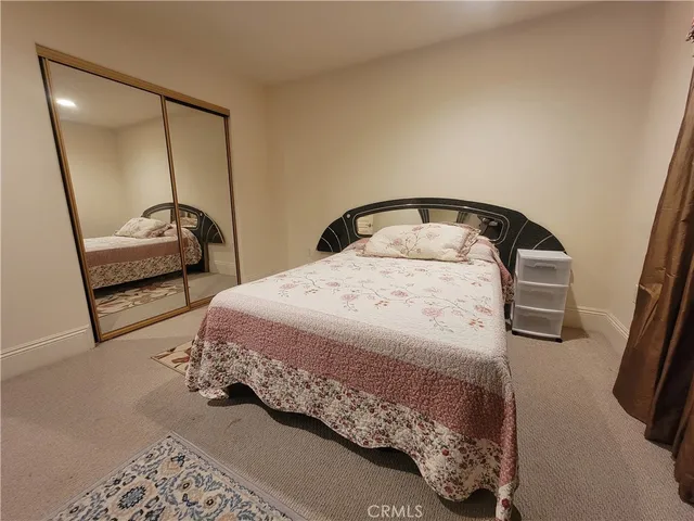 a bedroom with a bed and a mirror