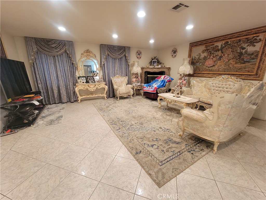 8009 Rose Street Paramount, CA 90723 - Photo 11 of 18 a living room with furniture a flat screen tv and a large window