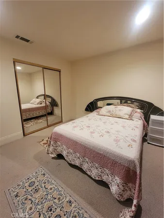 a bedroom with a bed and a mirror