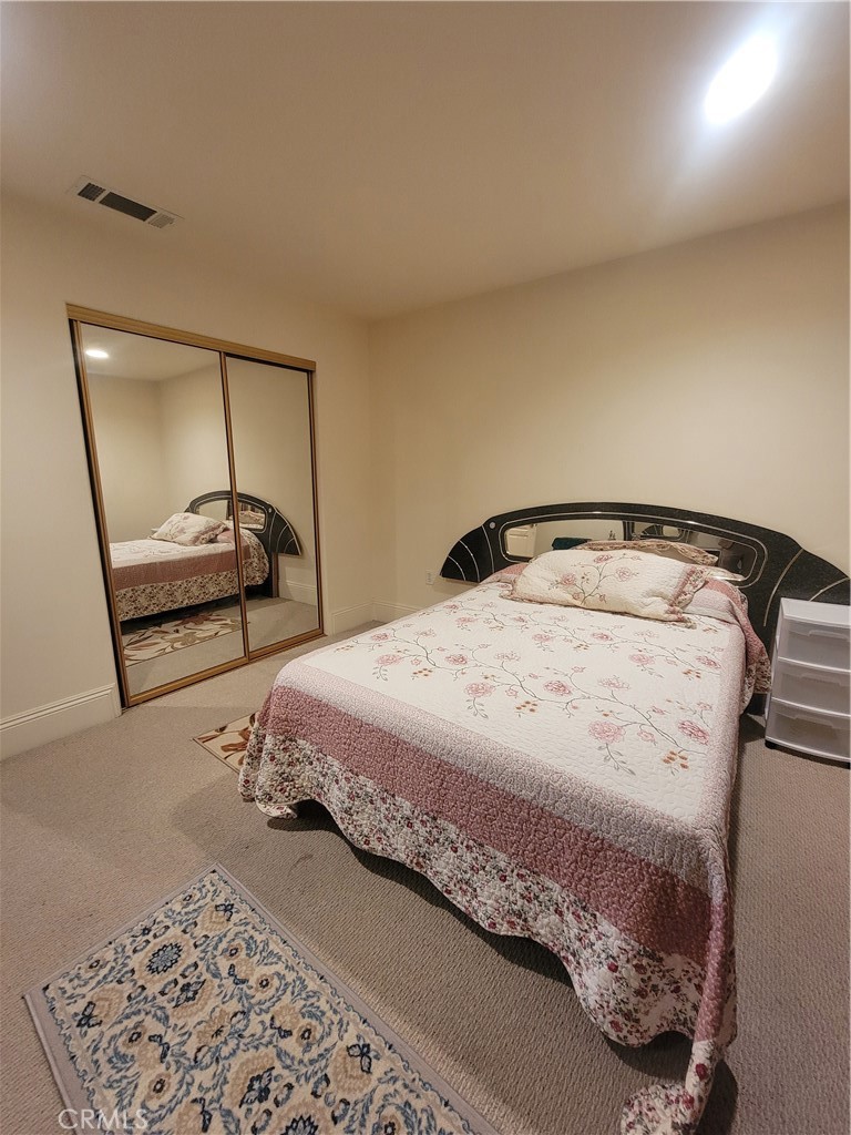 8009 Rose Street Paramount, CA 90723 - Photo 3 of 18 a bedroom with a bed and a mirror