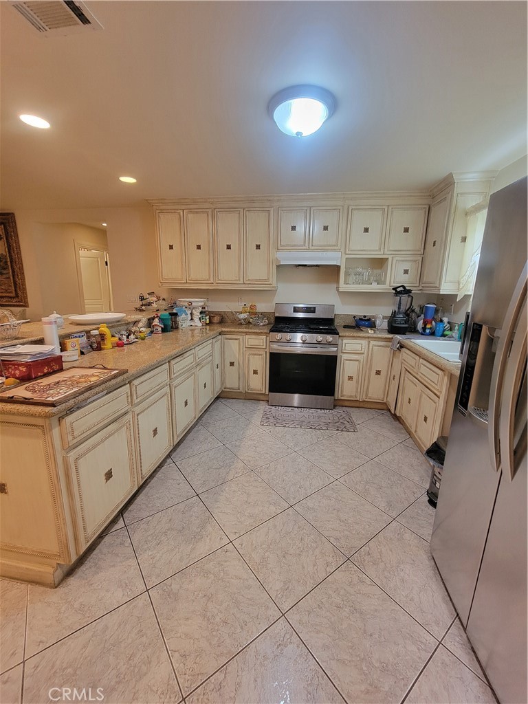 8009 Rose Street Paramount, CA 90723 - Photo 9 of 18 a kitchen with cabinets and appliances
