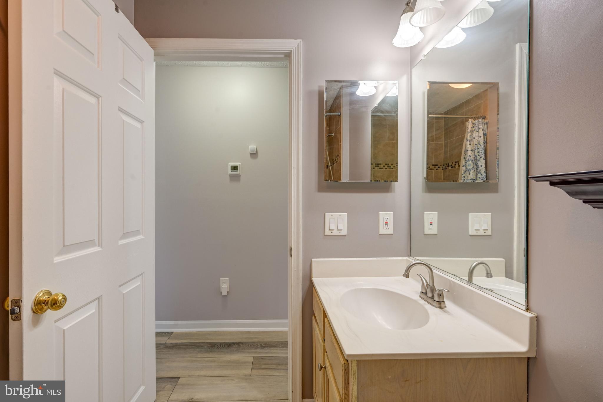 6495 Wesley Lane Elkridge, MD 21075 - Photo 11 of 37 a bathroom with a sink and a mirror