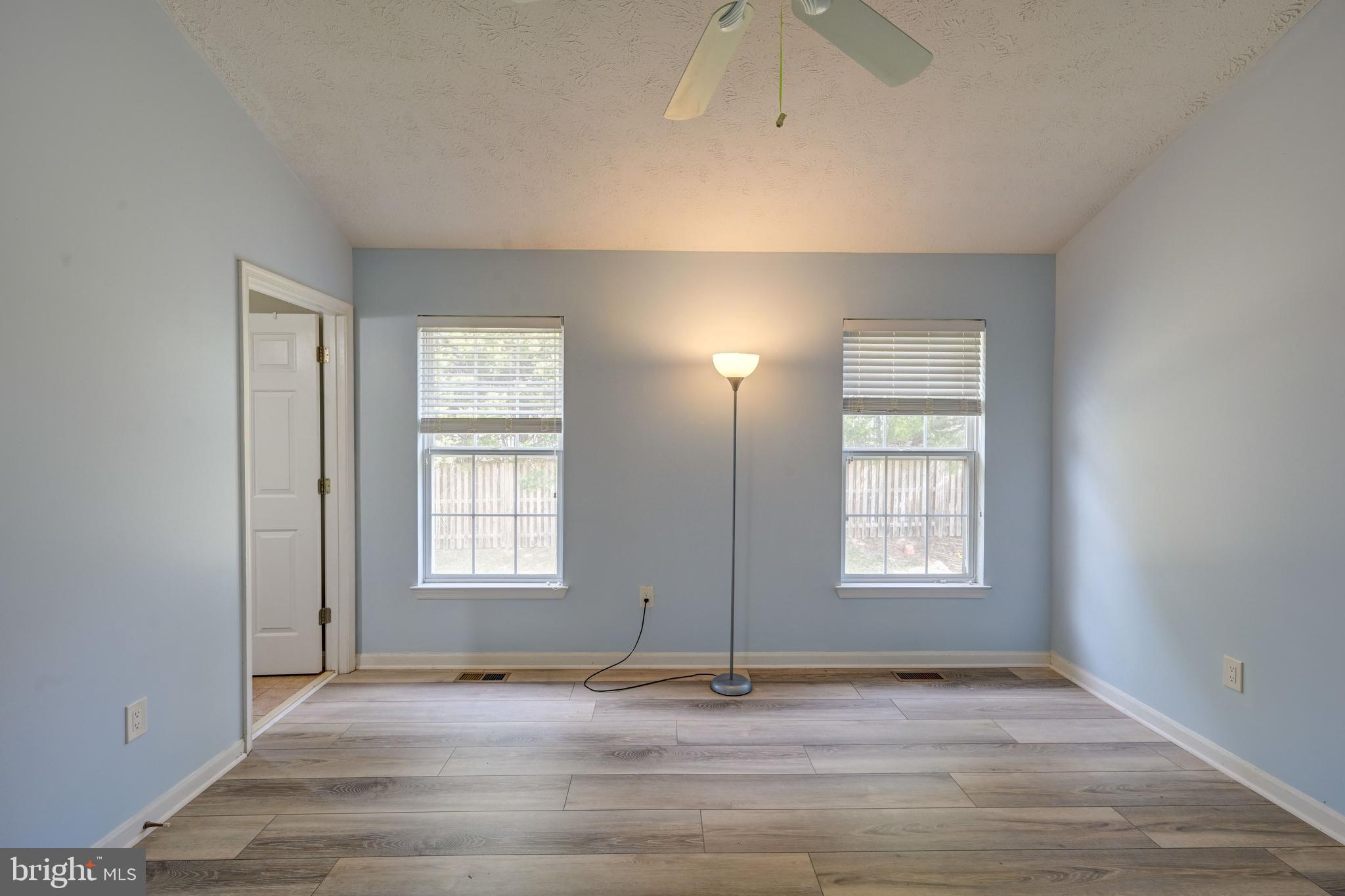 6495 Wesley Lane Elkridge, MD 21075 - Photo 12 of 37 an empty room with wooden floor and windows