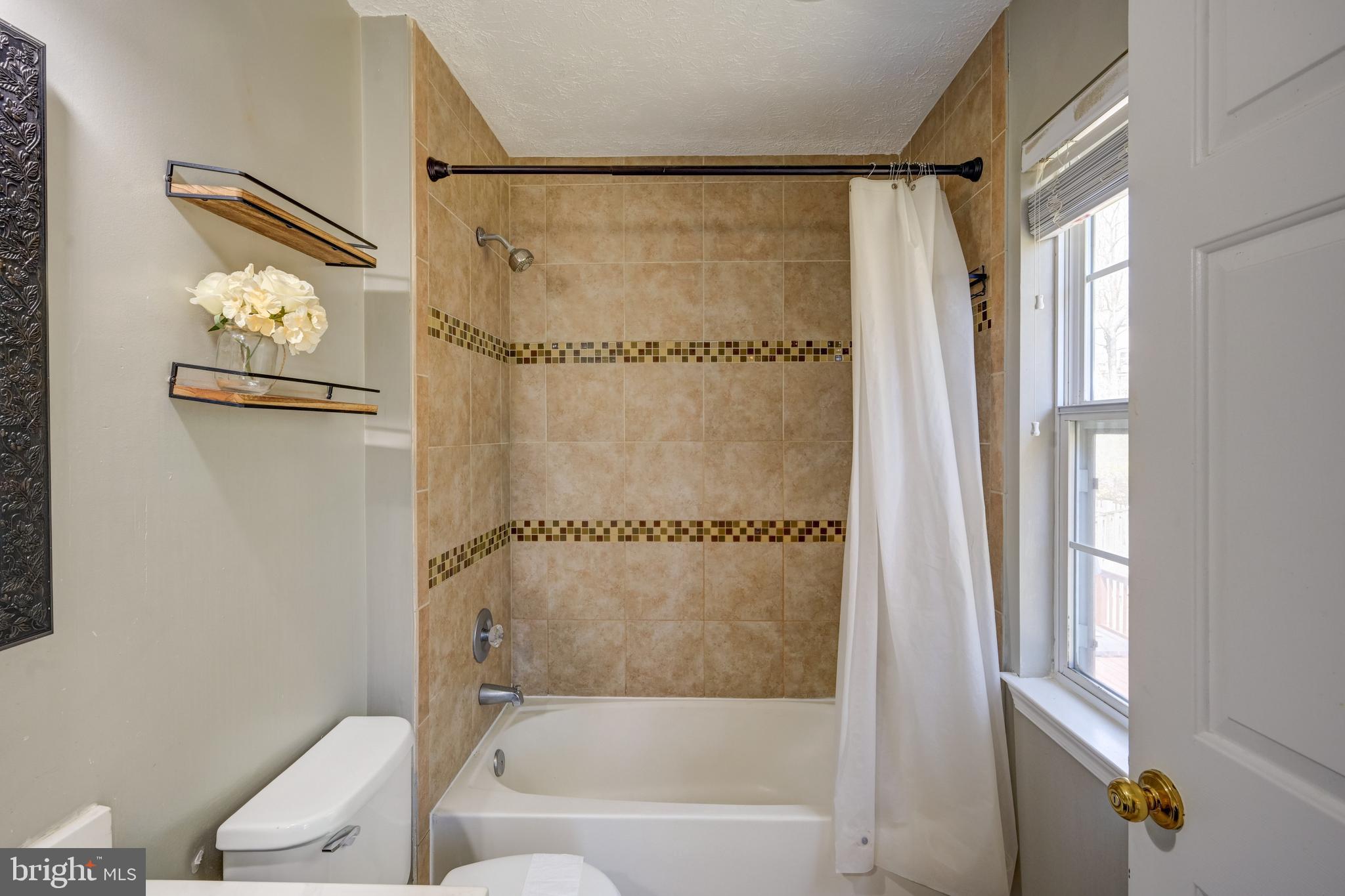 6495 Wesley Lane Elkridge, MD 21075 - Photo 15 of 37 a bathroom with a bathtub and a shower
