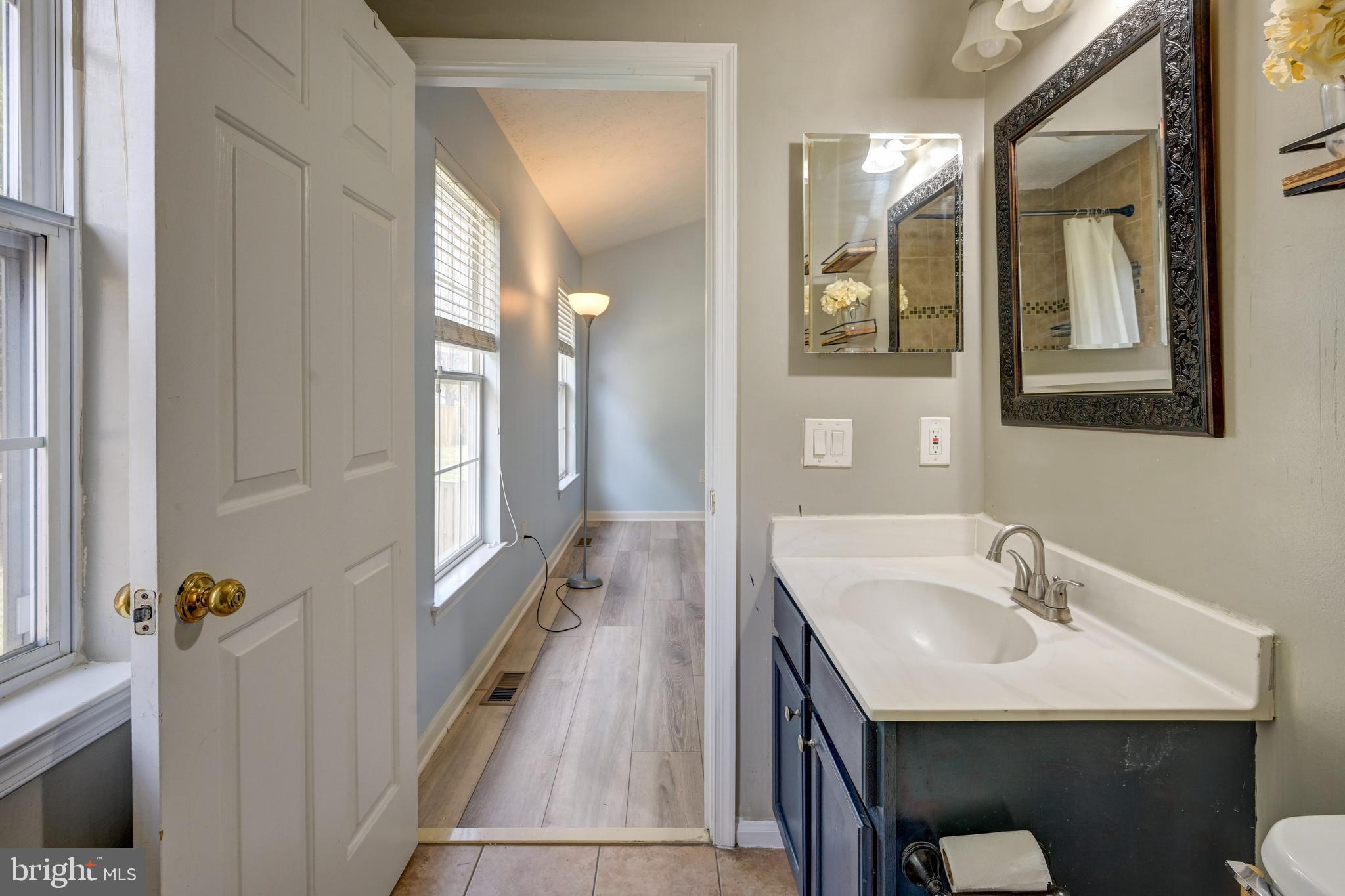 6495 Wesley Lane Elkridge, MD 21075 - Photo 17 of 37 a en suite bathroom with a sink and mirror