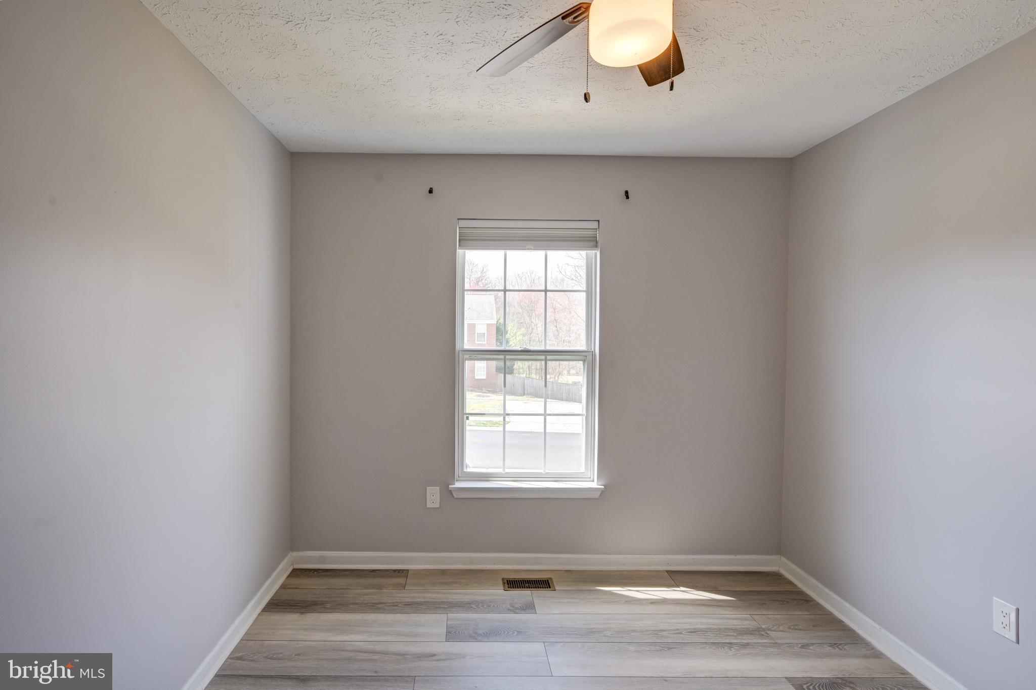 6495 Wesley Lane Elkridge, MD 21075 - Photo 18 of 37 an empty room with wooden floor and windows