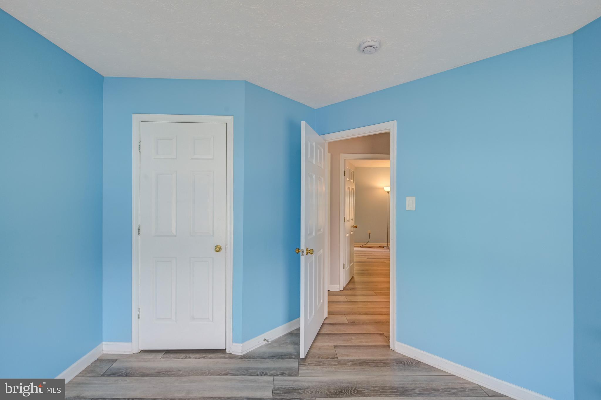 6495 Wesley Lane Elkridge, MD 21075 - Photo 21 of 37 a view of a hallway with wooden floor