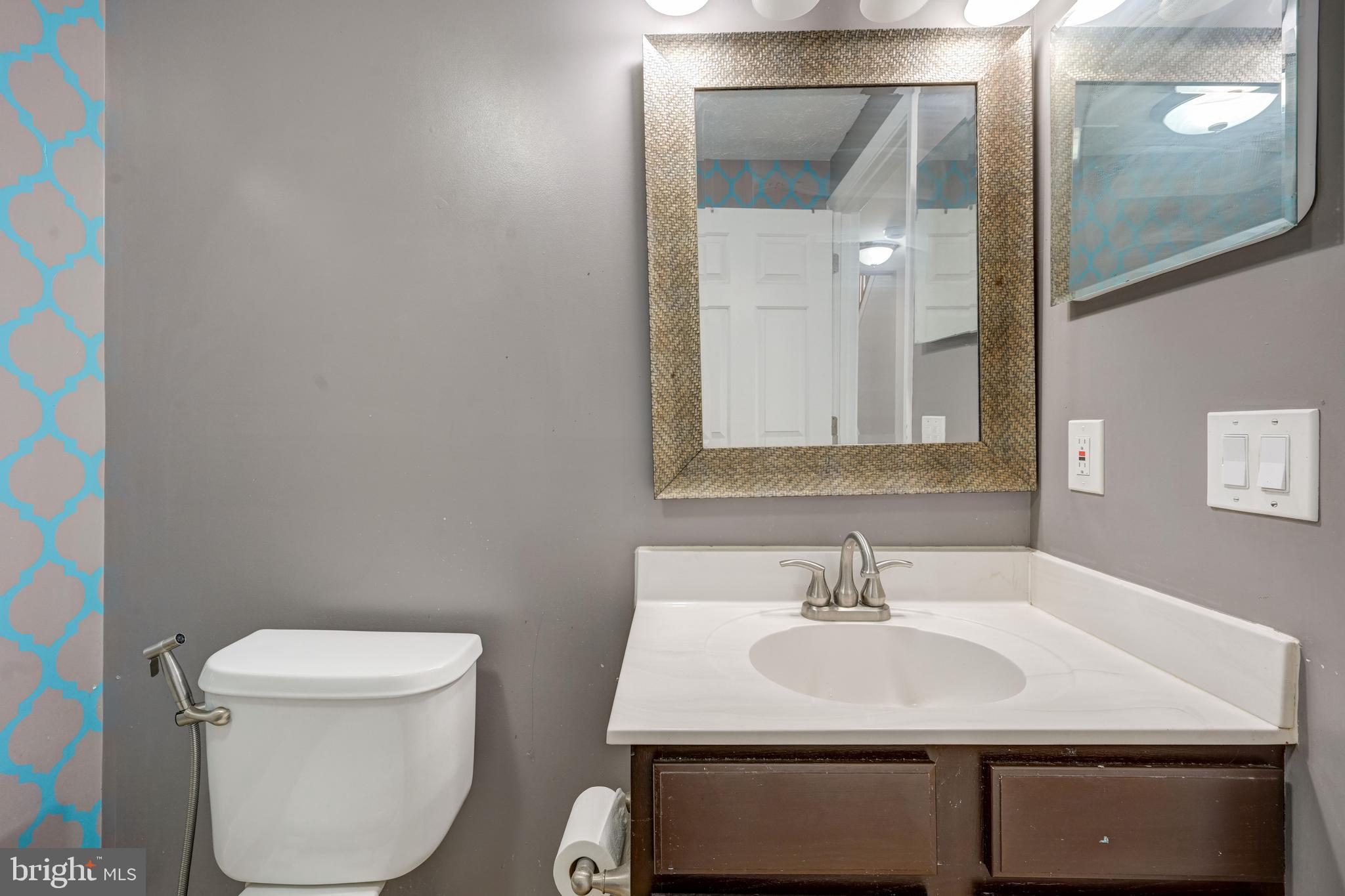 6495 Wesley Lane Elkridge, MD 21075 - Photo 26 of 37 a bathroom with a sink toilet and mirror