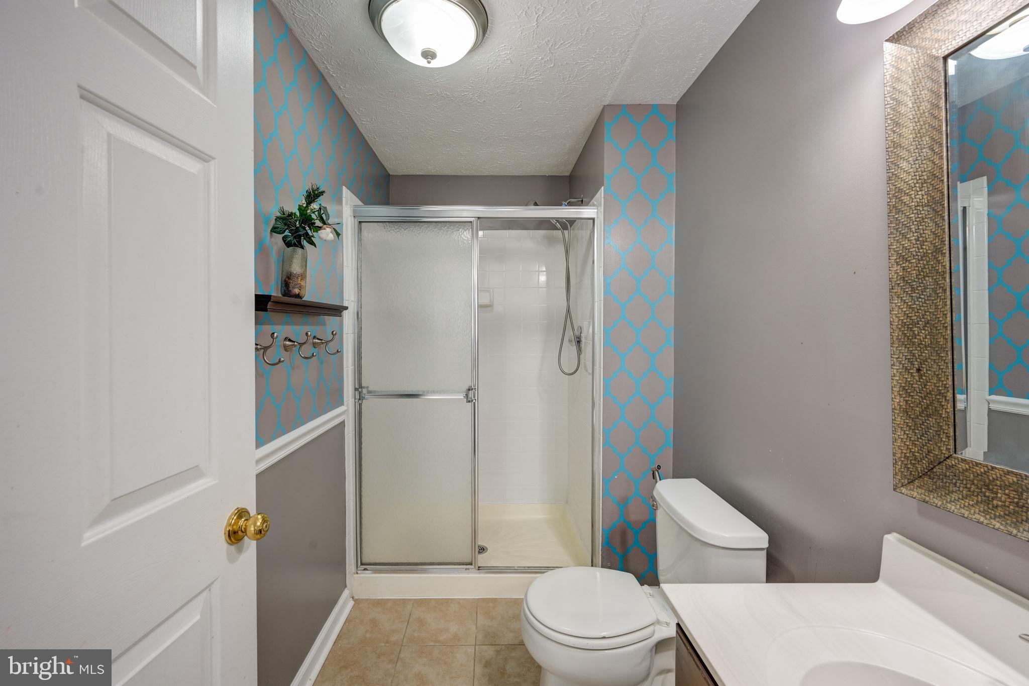 6495 Wesley Lane Elkridge, MD 21075 - Photo 27 of 37 a bathroom with a toilet and a shower