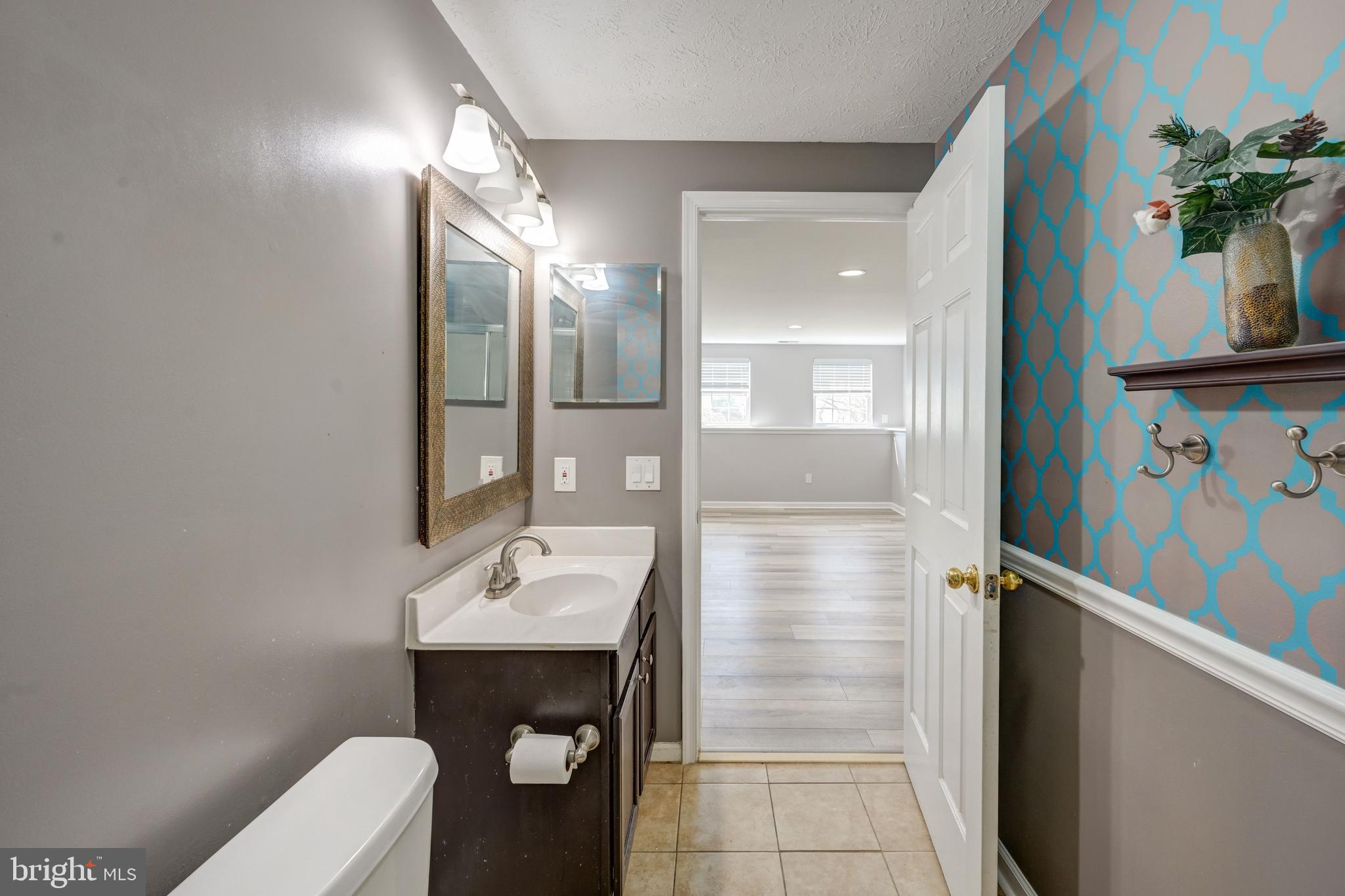 6495 Wesley Lane Elkridge, MD 21075 - Photo 28 of 37 a bathroom with a sink a toilet and shower