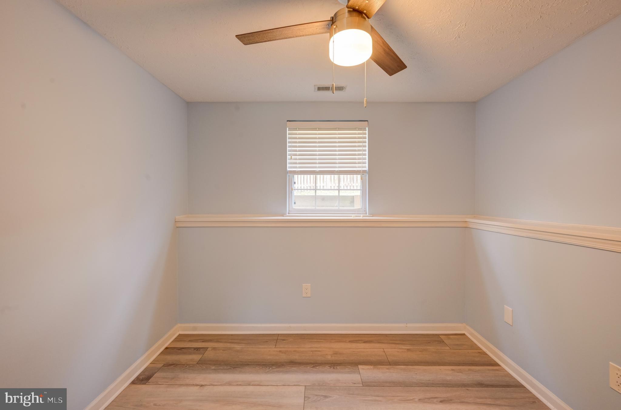 6495 Wesley Lane Elkridge, MD 21075 - Photo 29 of 37 a view of a room with wooden floor and fan