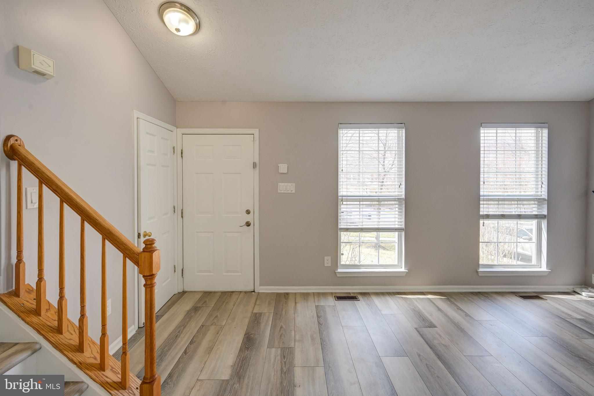 6495 Wesley Lane Elkridge, MD 21075 - Photo 4 of 37 a view of an empty room with wooden floor and a window