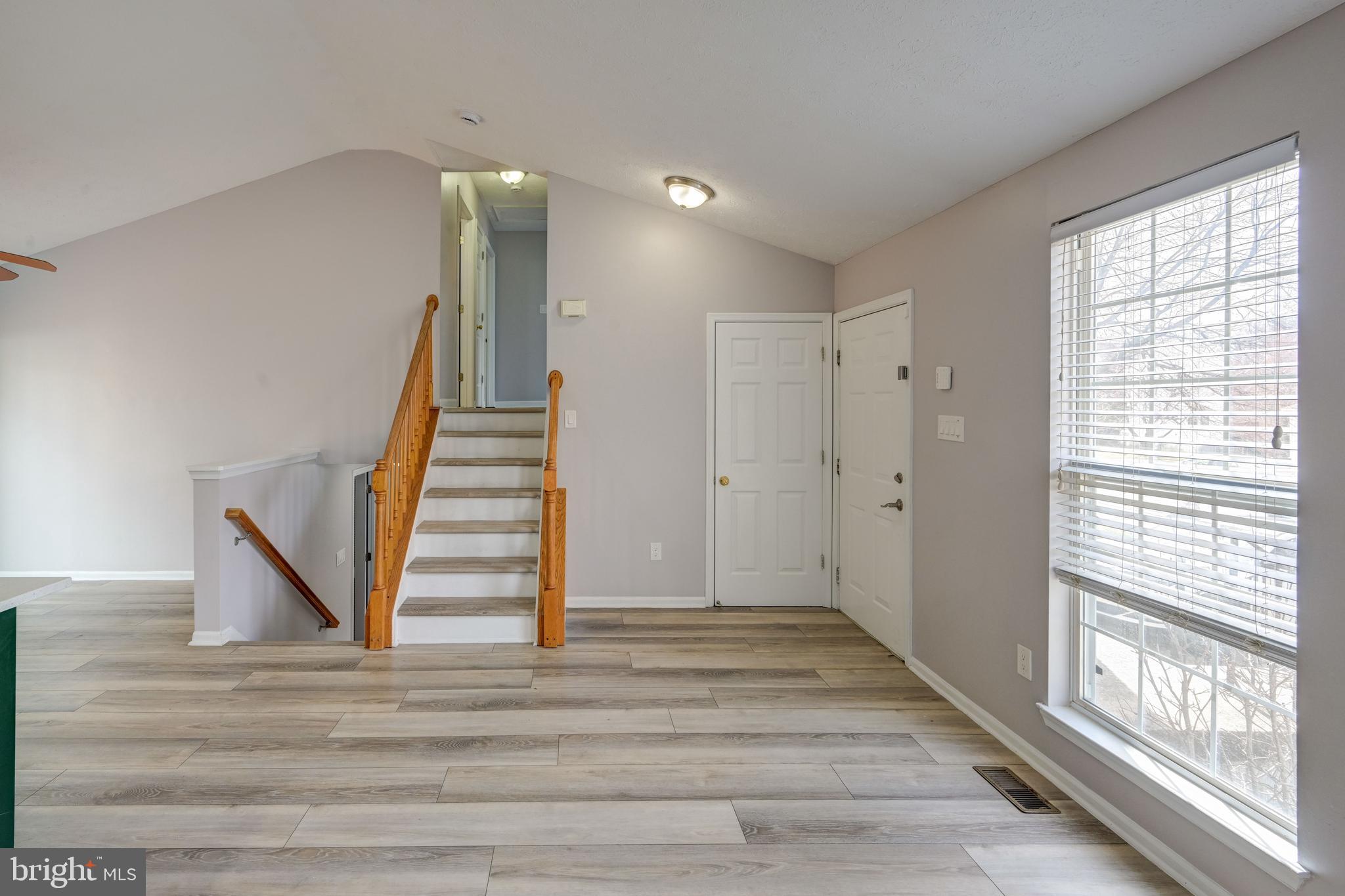 6495 Wesley Lane Elkridge, MD 21075 - Photo 5 of 37 a view of entryway and hall with wooden floor
