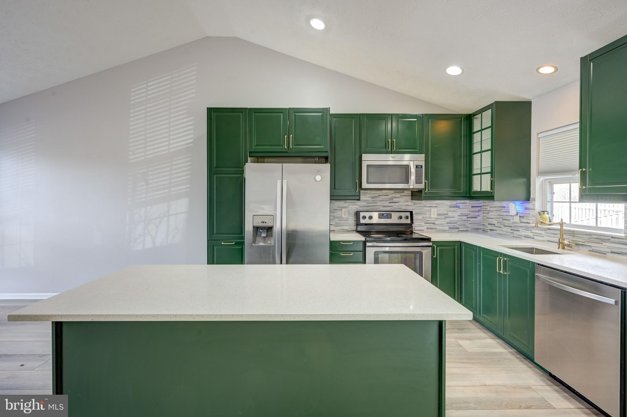 6495 Wesley Lane Elkridge, MD 21075 - Photo 6 of 37 a kitchen with stainless steel appliances a refrigerator sink and stove