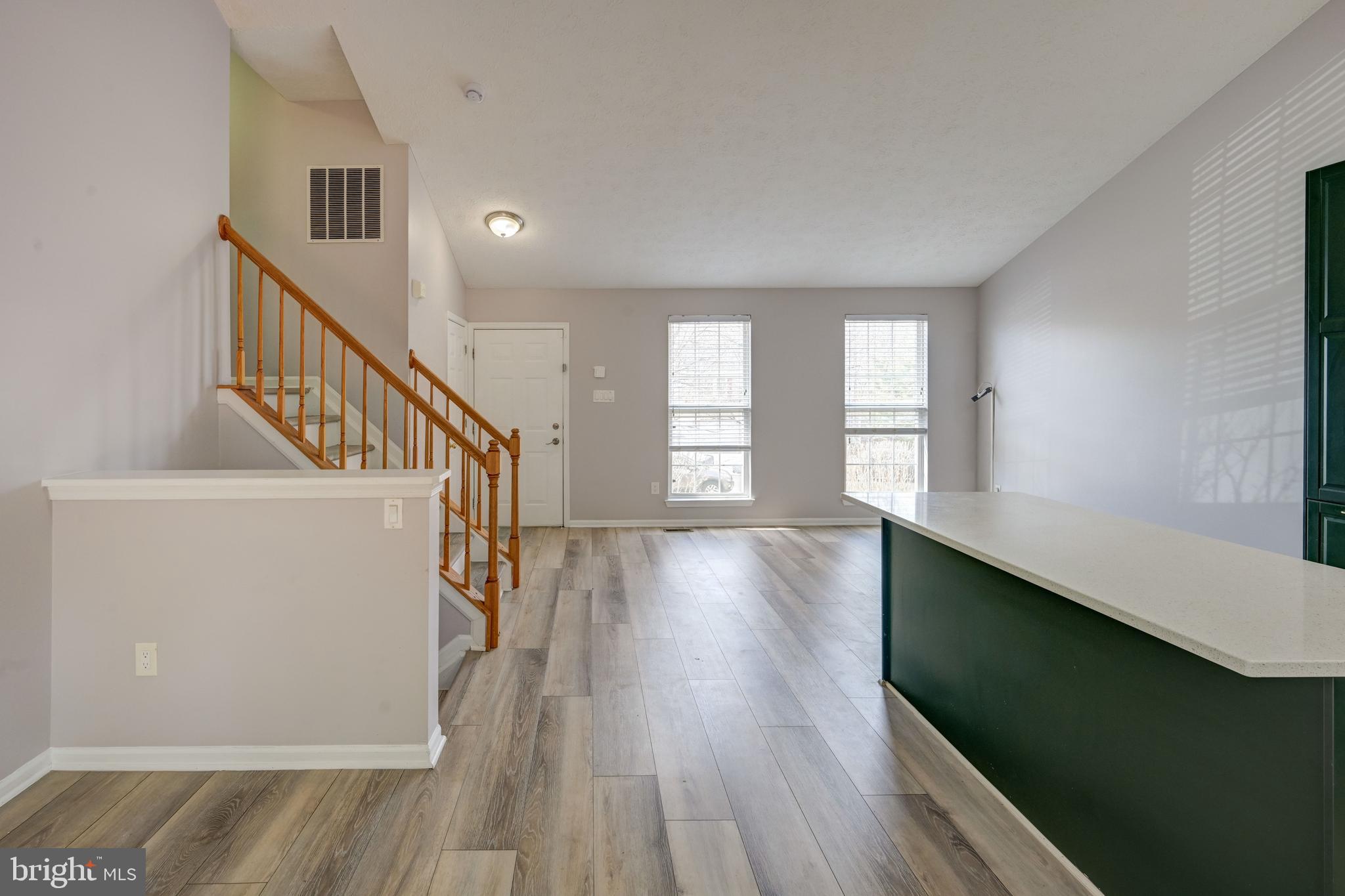 6495 Wesley Lane Elkridge, MD 21075 - Photo 8 of 37 a view of entryway and hall with wooden floor