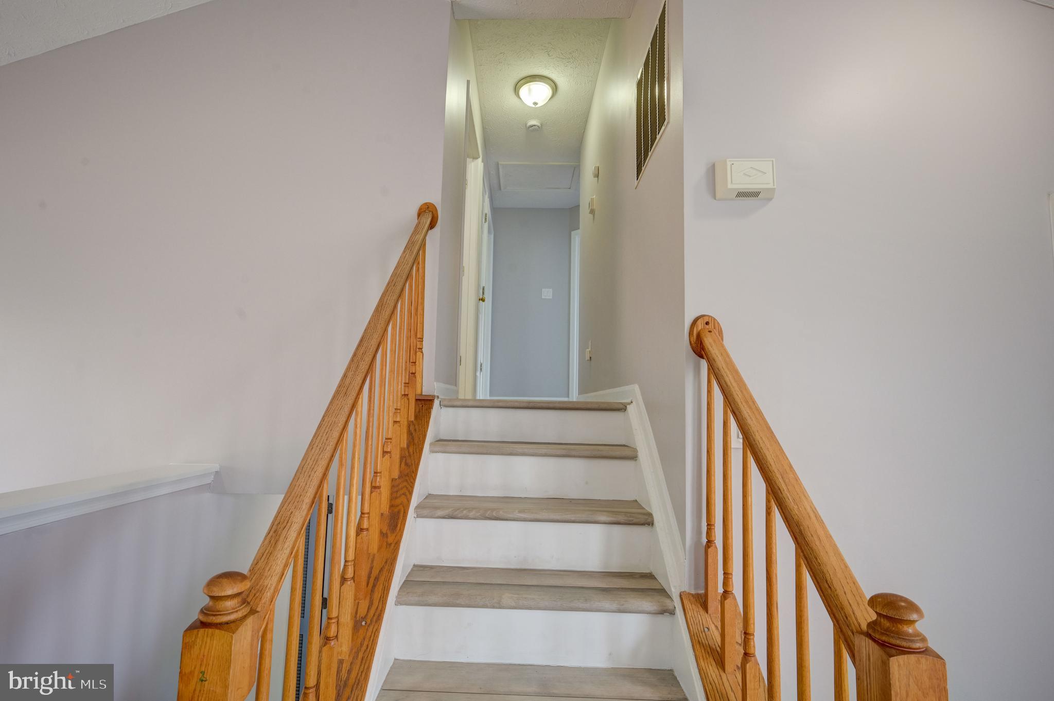 6495 Wesley Lane Elkridge, MD 21075 - Photo 9 of 37 a view of staircase with lots of frames on wall and windows
