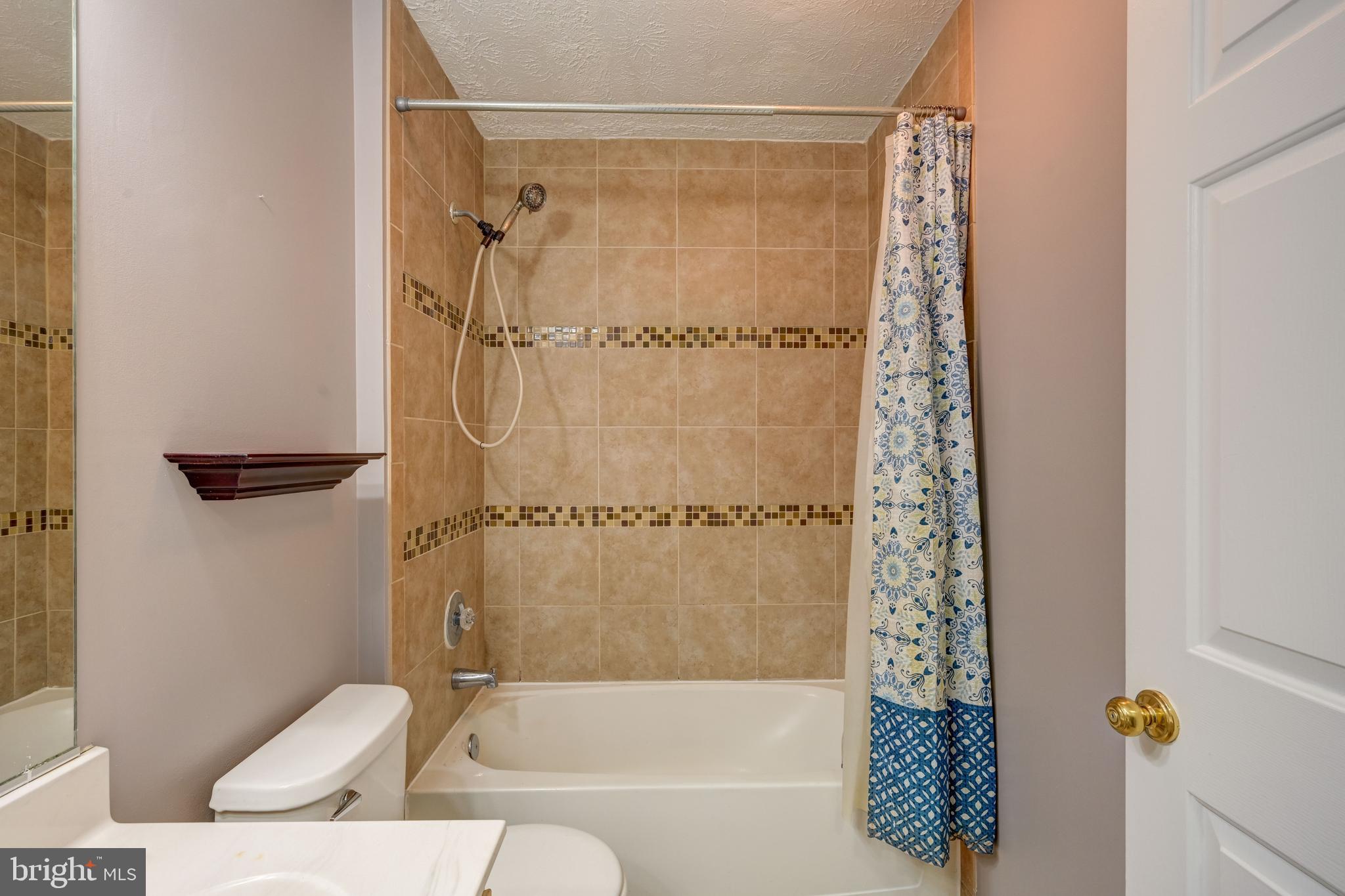 6495 Wesley Lane Elkridge, MD 21075 - Photo 10 of 37 a bathroom with a bathtub and shower