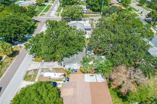 a kitchen with stainless steel appliances granite countertop a refrigerator stove top oven dining table and chairs
