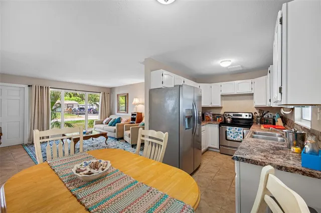 a living room with furniture and a flat screen tv with wooden floor