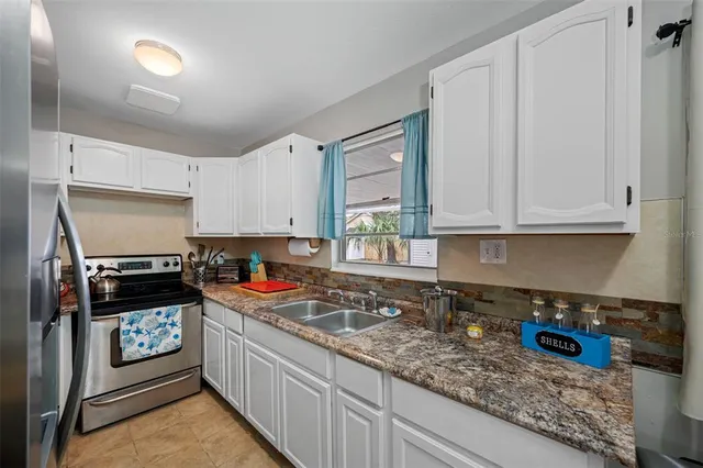 a bedroom with two beds and a flat screen tv