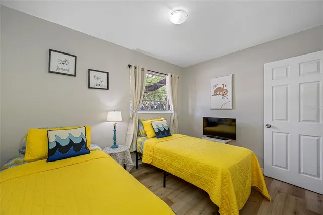 a bedroom with a bed and wooden floor