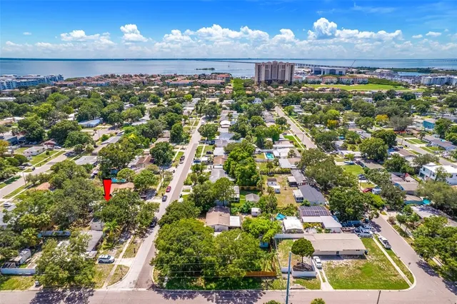 an aerial view of a house with a yard and garden