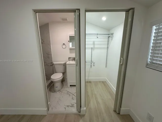a bathroom with a granite countertop toilet