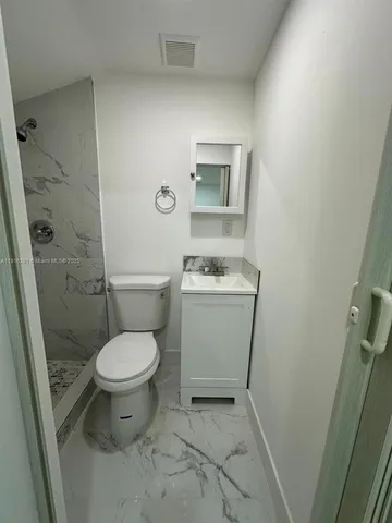a bathroom with a toilet and a sink