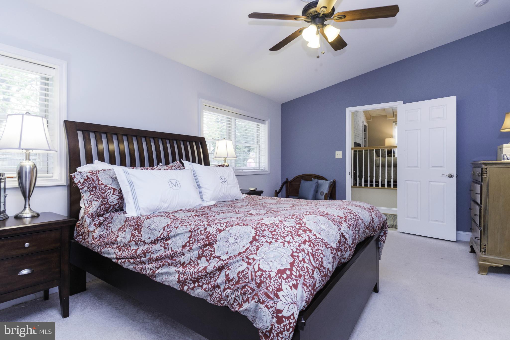 6600 Pine Road Alexandria, VA 22312 - Photo 12 of 28 a bedroom with a bed and a chandelier