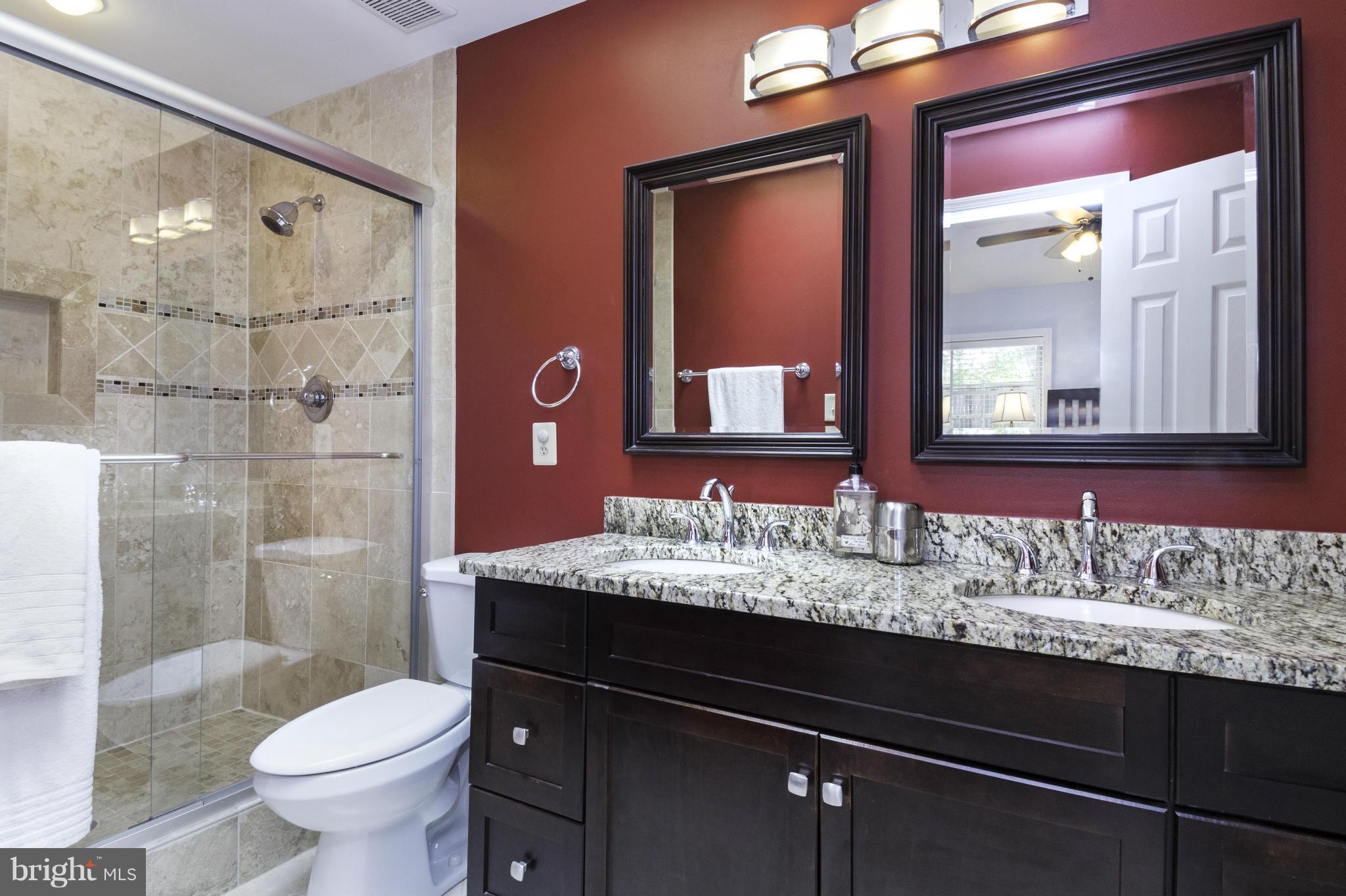 6600 Pine Road Alexandria, VA 22312 - Photo 14 of 28 a bathroom with a granite countertop sink toilet and shower