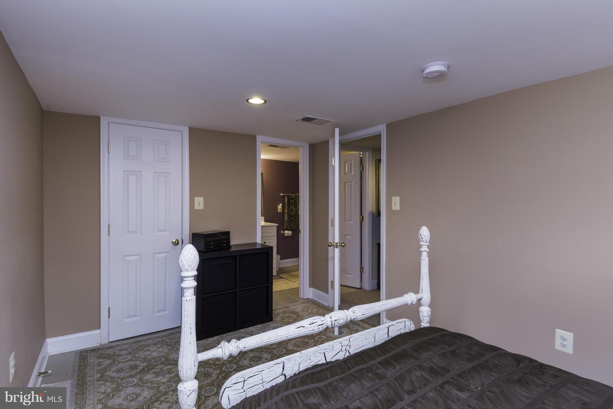6600 Pine Road Alexandria, VA 22312 - Photo 20 of 28 a bedroom with a bed and wooden floor